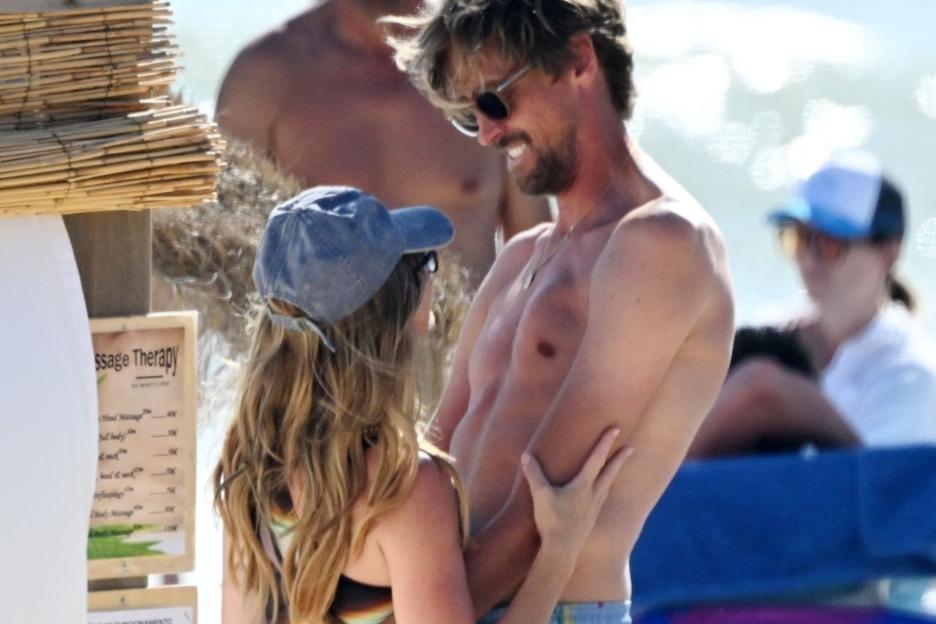 Abbey Clancy flashes her bum on the beach as she cosies up to hubby Peter Crouch