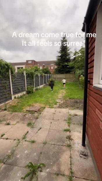 Backyard of a new home with two children running.