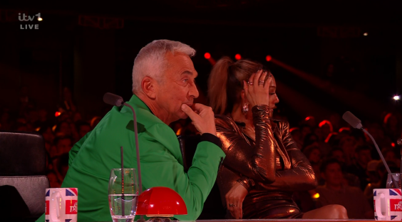 Screenshot of two judges at a talent show, one in a green jacket and the other in a gold dress.