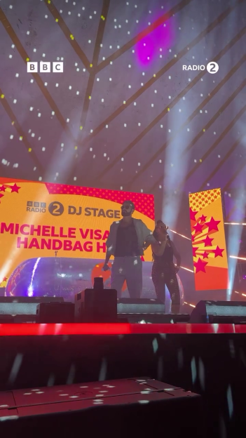 Rylan Clark and Michelle Visage performing on stage.