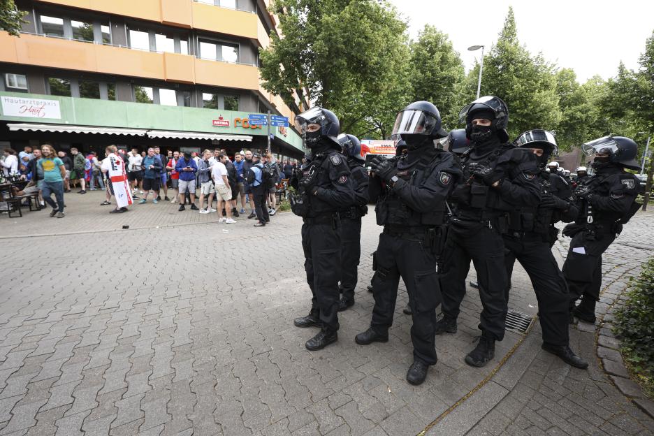 Police in riot gear monitoring England fans in Gelsenkirchen, Germany.