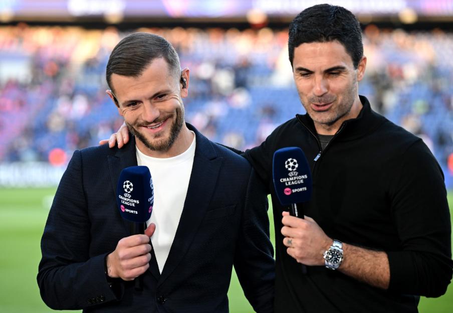PARIS, FRANCE - MAY 07: Jack Wilshere, Interim Head Coach of Norwich City, and Mikel Arteta, Manager of Arsenal, talk during a pitch side interview prior to the UEFA Champions League 2024/25 Semi Final Second Leg match between Paris Saint-Germain and Arsenal FC at Parc des Princes on May 07, 2025 in Paris, France. (Photo by Stuart MacFarlane/Arsenal FC via Getty Images)