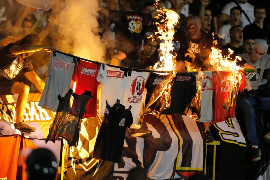 Burning Red Star Belgrade supporters' t-shirts at a Partizan Belgrade soccer match.