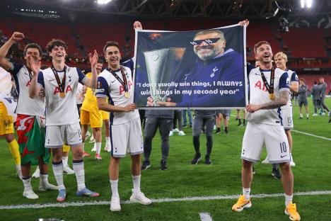 Tottenham Hotspur players holding a banner celebrating their Europa League victory.