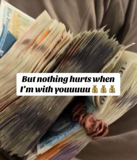 Large stacks of British pounds secured with a hair tie.