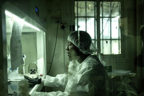 A researcher in protective gear works in a Lassa fever laboratory.