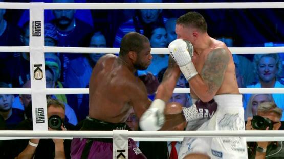 two boxers are fighting in a ring with a ko banner on the side