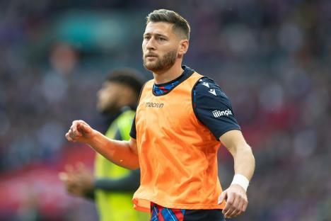 Joel Ward of Crystal Palace warming up on the touchline.