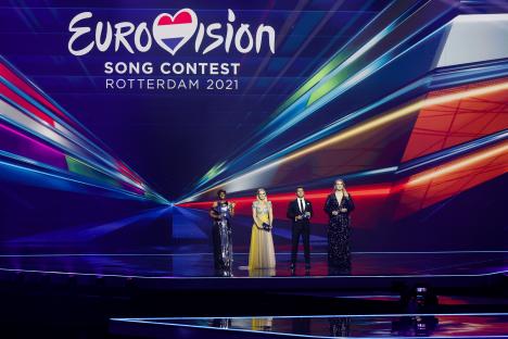 Four Eurovision Song Contest hosts on stage.
