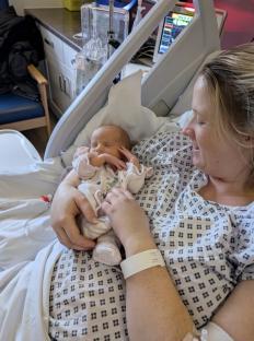Mother holding her newborn baby in a hospital.