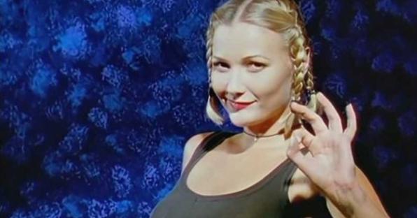 a woman in a black tank top is giving the ok sign .