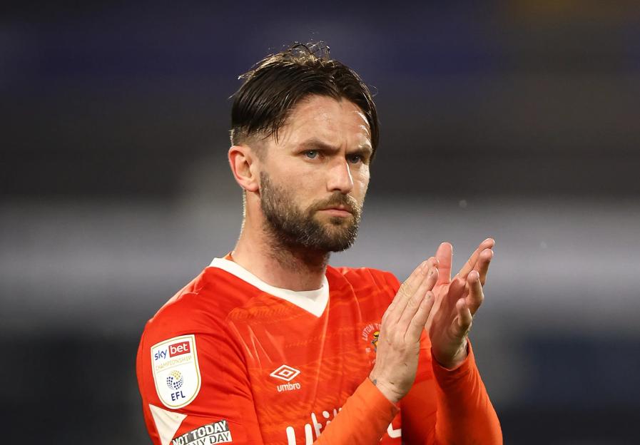 Henri Lansbury of Luton Town applauding during a soccer match.
