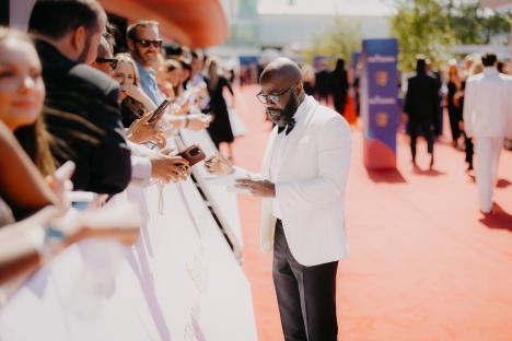 Melvin Odoom signing autographs at the BAFTA Television Awards.