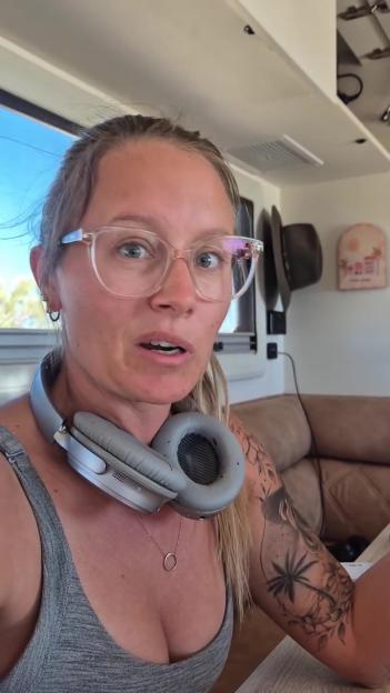 Woman speaking to camera, wearing headphones.