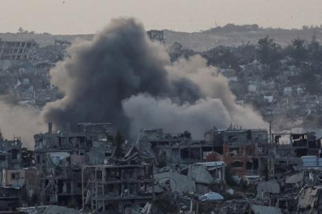 Smoke and rubble in a war-torn city.