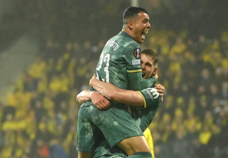 Two soccer players celebrating a goal.