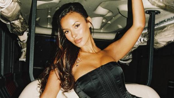 Maya Jama shows off toned body as she poses in figure-hugging black corset and patterned slacks
