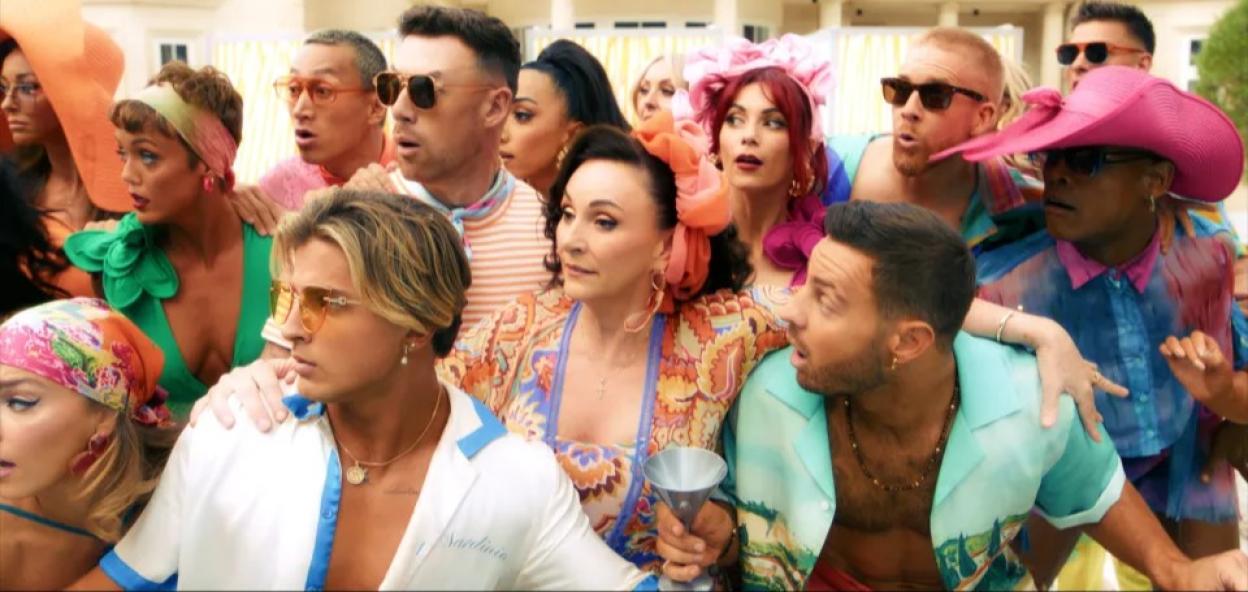 People in colorful clothing looking surprised.