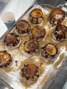 Crème brûlée doughnuts on a tray.