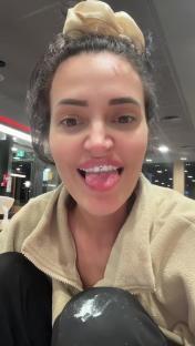 Woman showing off her tongue piercing.