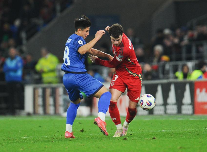 CARDIFF, WALES - MARCH 22: Wales' Neco Williams battles with Kazakhstan's Dastan Satpaev during the FIFA World Cup 2026 European Qualifier between Wales and Kazakhstan at Cardiff City Stadium on March 22, 2025 in Cardiff, Wales. (Photo by Ian Cook - CameraSport via Getty Images)