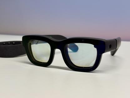 Black smart glasses with a dark band.