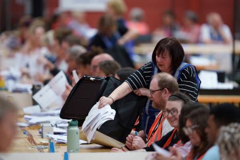 Election officials counting ballots at a by-election.