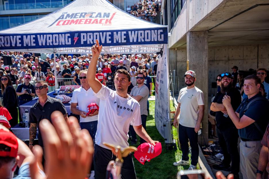 Right-wing activist Charlie Kirk throws hats to a crowd at a Utah Valley University speaking event.