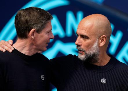 Oliver Glasner and Josep Guardiola talking.