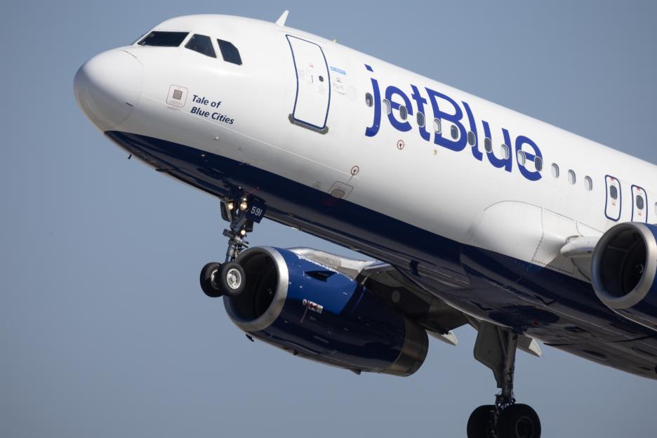 Close-up of a JetBlue Airways plane taking off.
