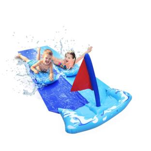 Two children sliding down an inflatable water slide.
