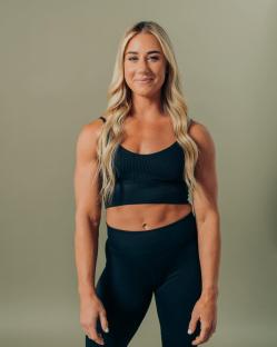 Portrait of a woman in black athletic wear.