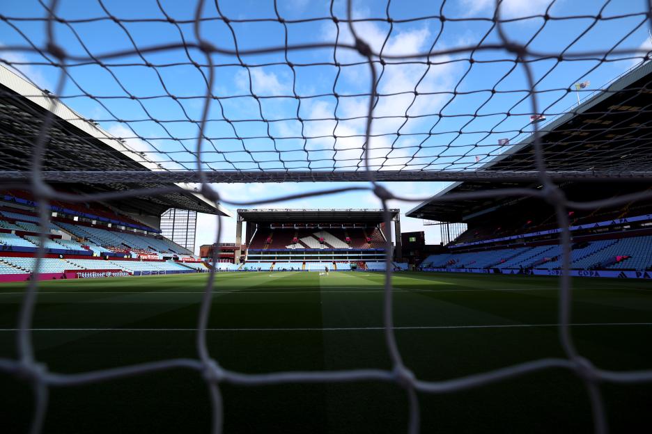 View of a soccer stadium through the goal net.