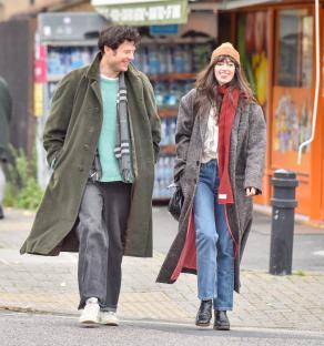James Norton walking arm-in-arm with his girlfriend.