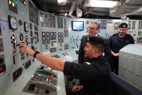 Prime Minister Keir Starmer with Royal Navy members aboard a ship.