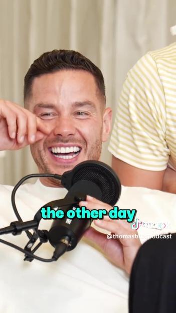 Screenshot of Scott Thomas laughing while speaking into a microphone on the Thomas Bros Podcast.