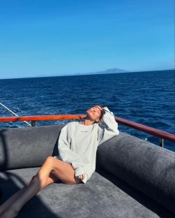 Charley Webb relaxing on a boat.