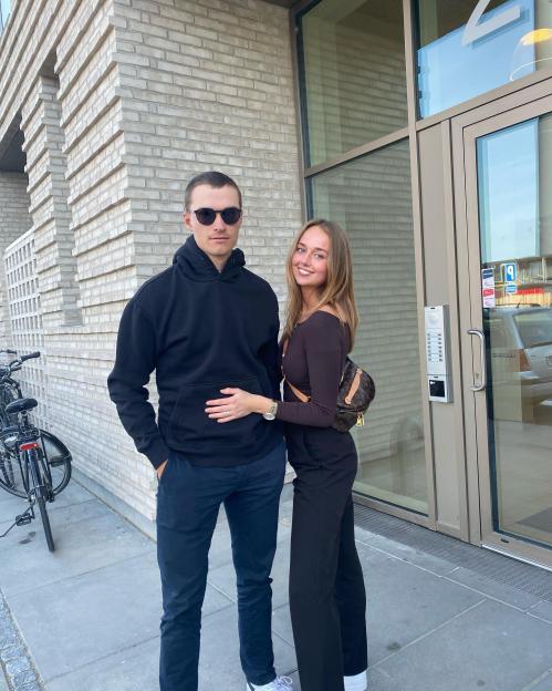 Julie Sander Danielsen and Rasmus Hojgaard posing outdoors.