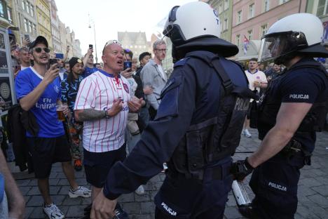 Riot police confronting Chelsea soccer fans.