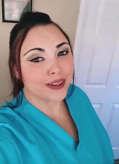 Woman in teal scrubs.