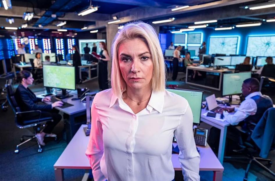 Georgina Bradley from Hunted Channel 4 in an office with several computers.