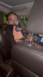 Uber driver pointing a gun at a passenger.