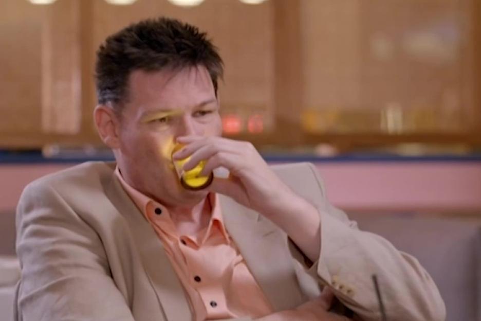 Mark Labbett asleep while drinking from a glass.