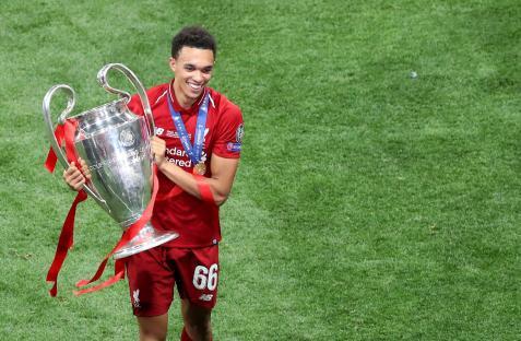 Trent Alexander-Arnold of Liverpool holding the UEFA Champions League trophy.