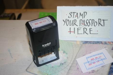 Passport stamp and sign that says