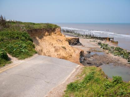 Severe coastal erosion causing road collapse in Happisburgh.