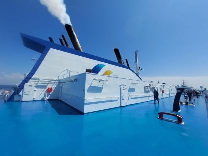 Ferry deck with smokestacks and exercise equipment.