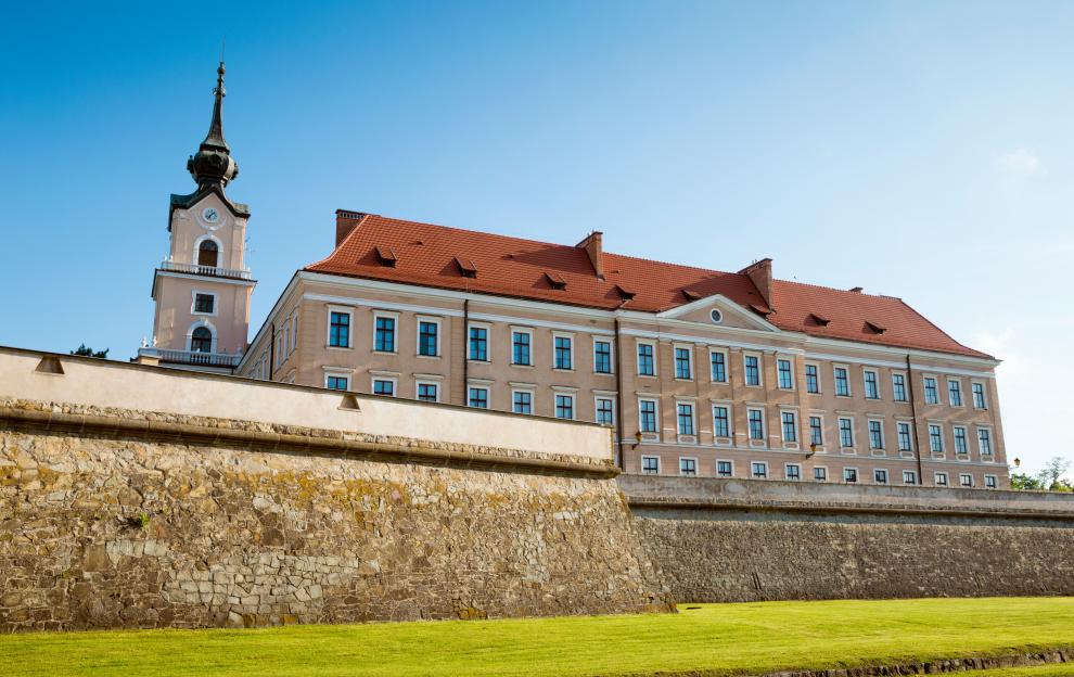 Castle in Rzeszow, Poland, with a visible stone wall and a tall clock tower.