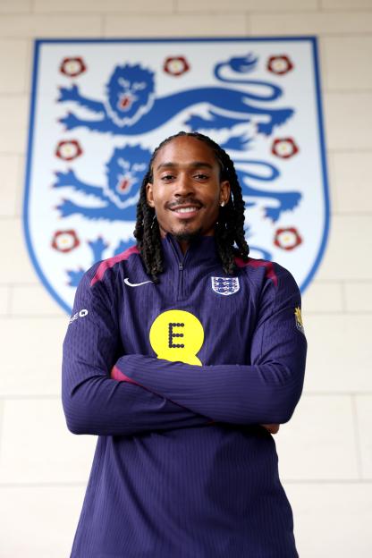 Djed Spence of England poses in a team tracksuit.