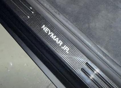 Close-up of a car's floor mat and door sill, showing